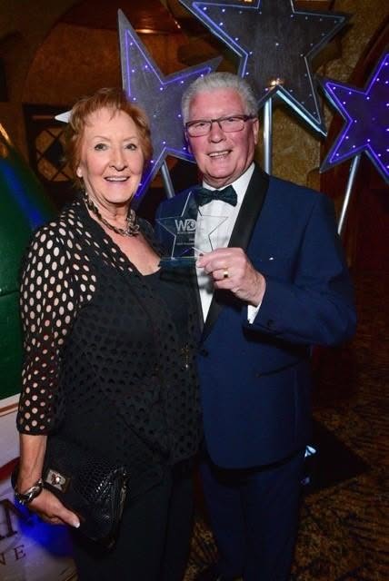 Len Armstrong receiving an award at a dance event
